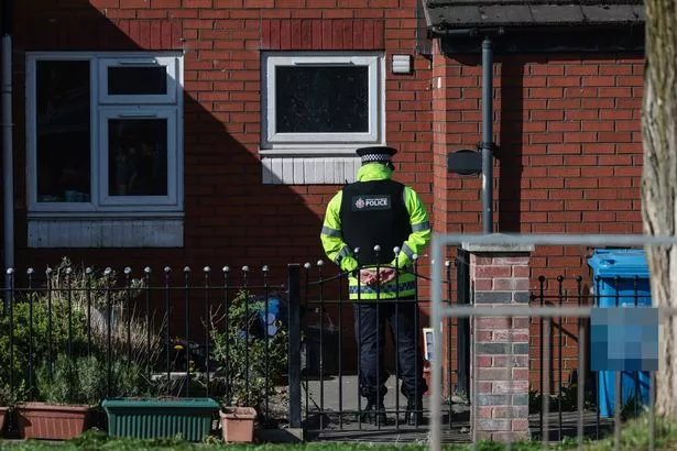 Police guard a property on Queens Road