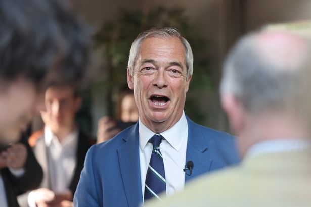 Reform UK leader Nigel Farage with chatting with party members during a visit to Morpeth in Northumberland.