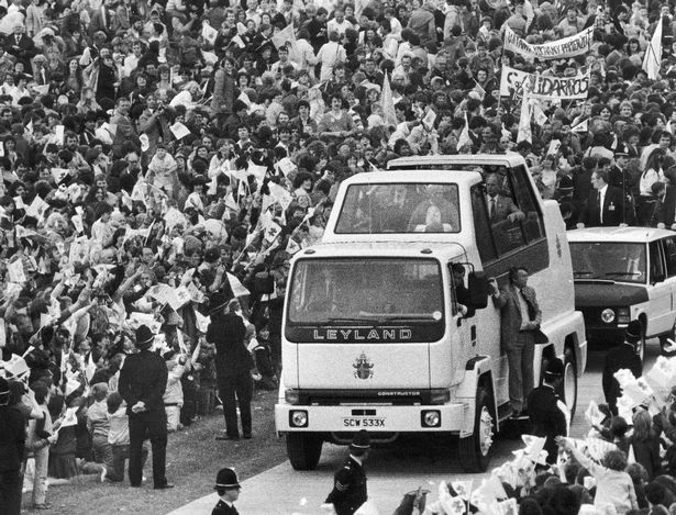 John Paul II waves to crowds from his British Leyland Popemobile