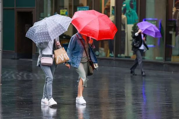 People brave the wind and rain in Liverpool city centre