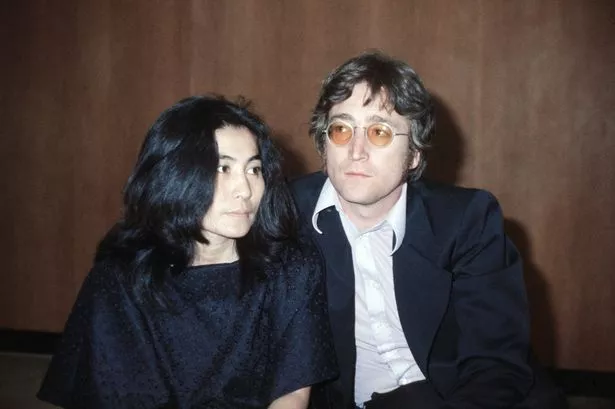 John Lennon with his wife Yoko Ono at Heathrow Airport, London in 1971