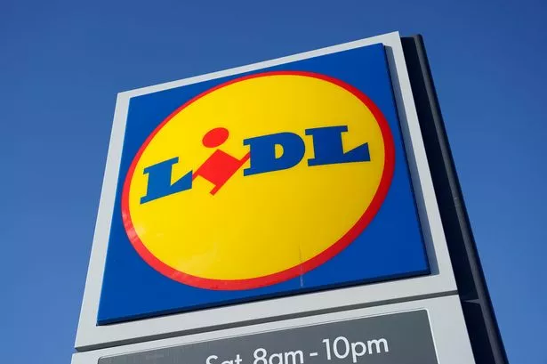 This photo shows the a sign for Lidl against a blue sky. 