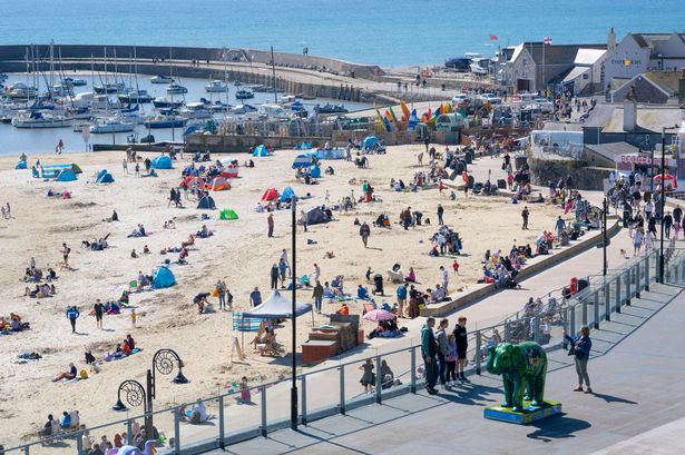 People pictured enjoying the beach at Lyme Regis