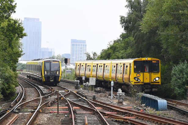 The new Merseyrail train (left) and old at Sandhills Station