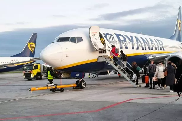 London, United Kingdom, March 24, 2024: Passengers Boarding Ryanair Aircraft at Sunset.