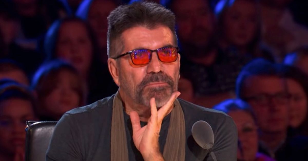 Louise Hall in a black top, floral shirt and blue jeans on the Britain's Got Talent stage with a microphone in an audition.
