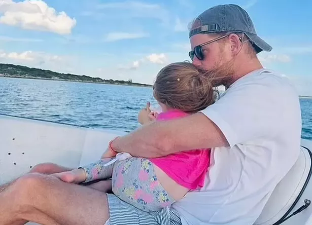 Prince Harry holding Lilibet whilst on a speed boat 