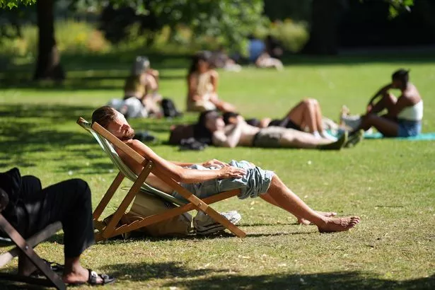 People enjoy the hot weather in St James's Park in central London