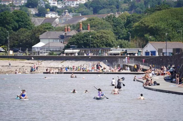 People enjoy the warm weather at Clevedon Marine Lake in Clevedon. 