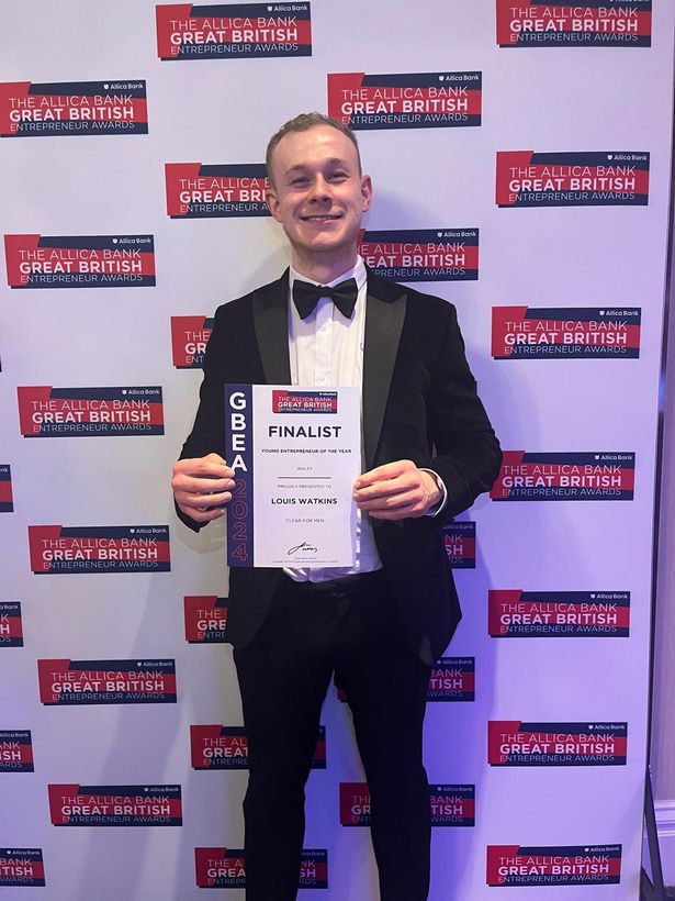 A man holding an award certificate