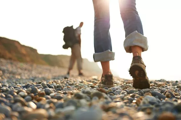 Woman and man walking on a beach