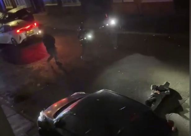 Armed police storm a Salford street with a suspect on the ground after a weapon is pointed at a crowd