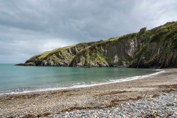 The beach at Aberfforest with an imposing cliff in the background