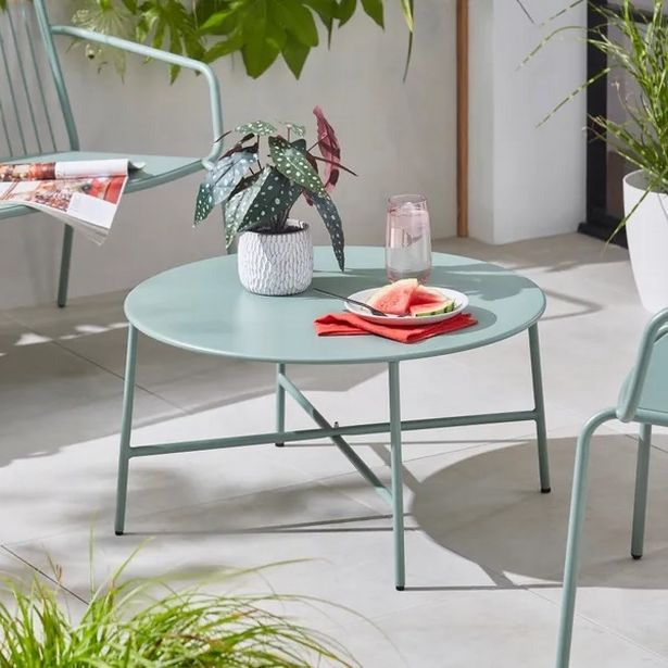 Photo shows light blue table and chairs set in garden