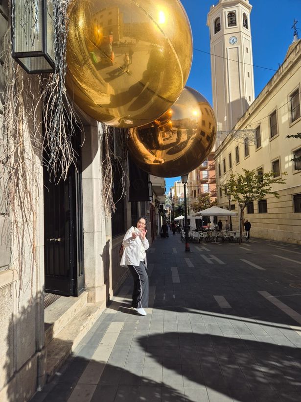 Louise underneath giant baubles in December in Alicante