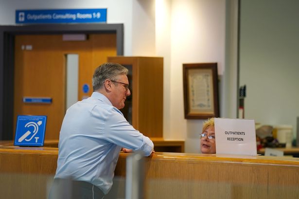 Prime Minister Sir Keir Starmer talks to staff during a visit to Rossendale Primary Health Care Centre in Lancashire