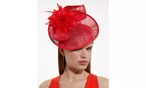 model wearing red Karen Millen fascinator
