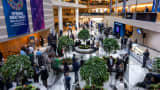 Guests and attendeess mingle and walk through the atrium during the IMF/World Bank Group Spring Meetings at the IMF headquarters in Washington, DC, on April 24, 2025. 