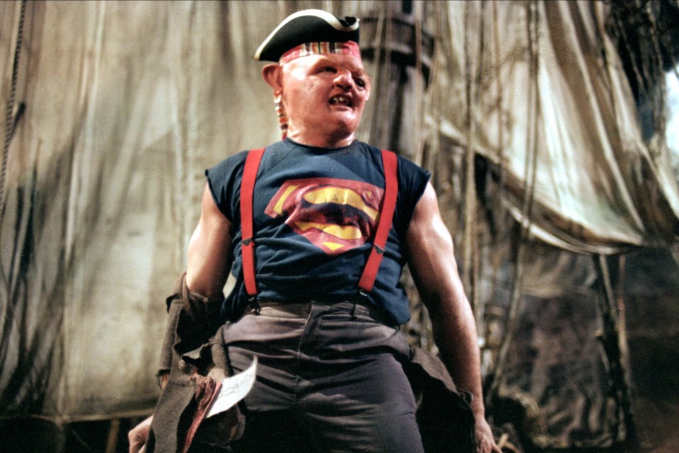 Sloth from *The Goonies* wearing a Superman shirt.