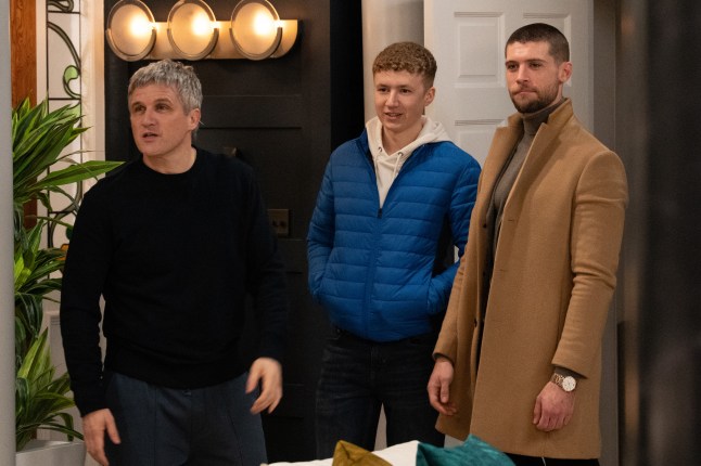 Caleb Miligan, Noah Dingle and Joe Tate standing in Mill Cottage in Emmerdale.