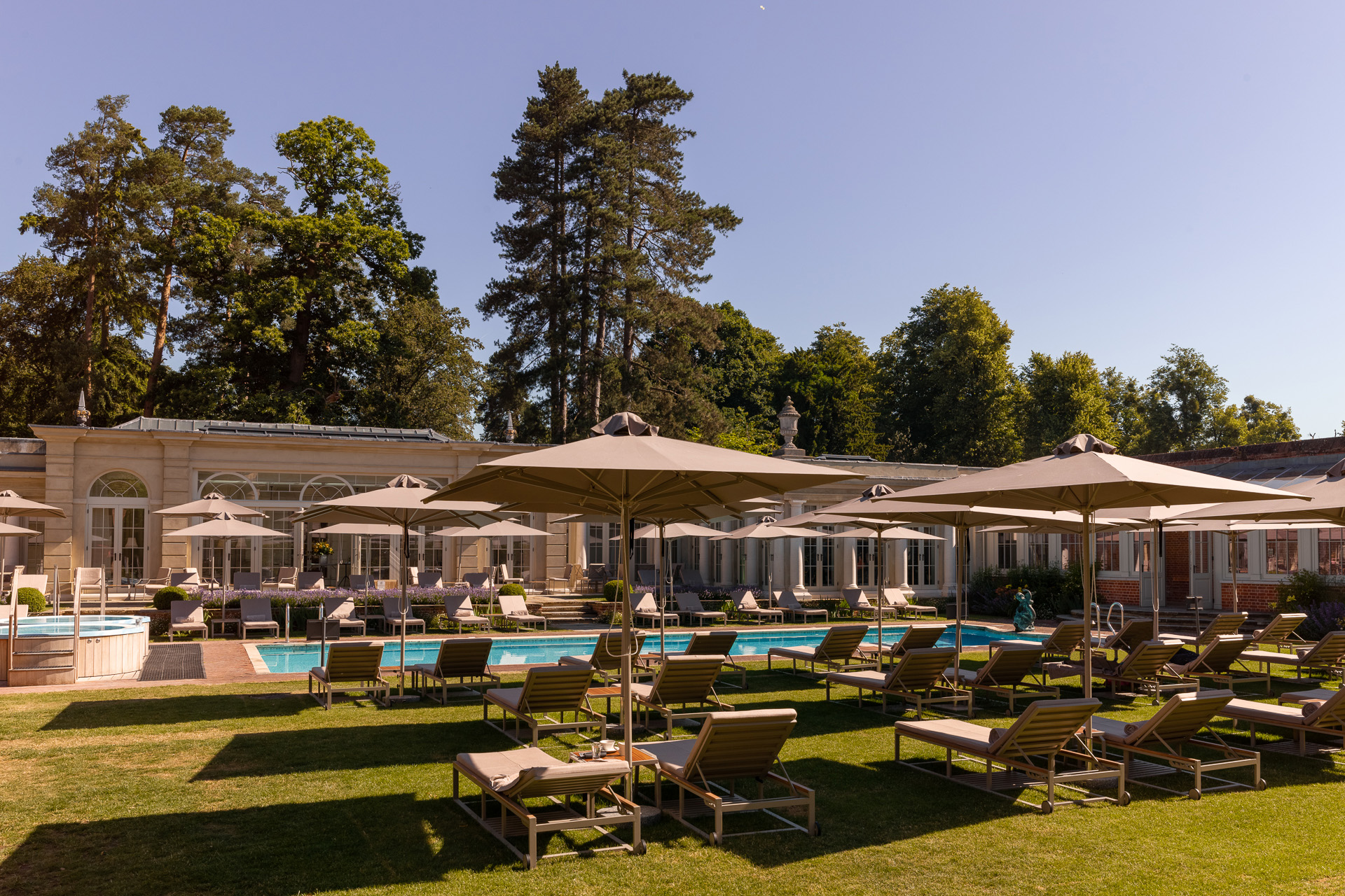 Spa loungers arranged around a pool