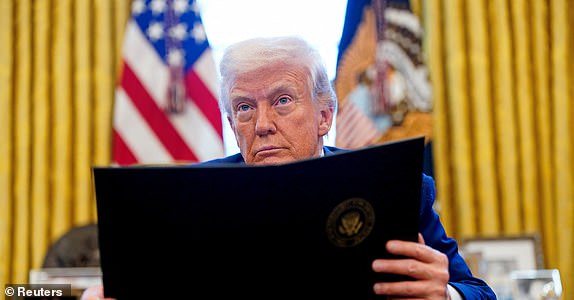 U.S. President Donald Trump looks on, as he signs executive orders and proclamations in the Oval Office at the White House in Washington, D.C., U.S., April 9, 2025. REUTERS/Nathan Howard