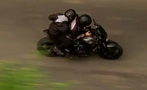 Jack Fagan driving the motorcycle with his pillion passenger, Connor Mitchell.