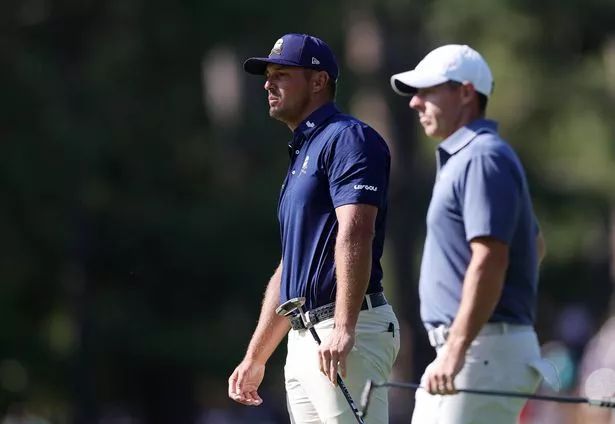 AUGUSTA, GEORGIA - APRIL 13: (L-R) Bryson DeChambeau of the United States and Rory McIlroy of Northern Ireland wait on the tenth hole during the final round of the 2025 Masters Tournament at Augusta National Golf Club on April 13, 2025 in Augusta, Georgia. (Photo by Andrew Redington/Getty Images)