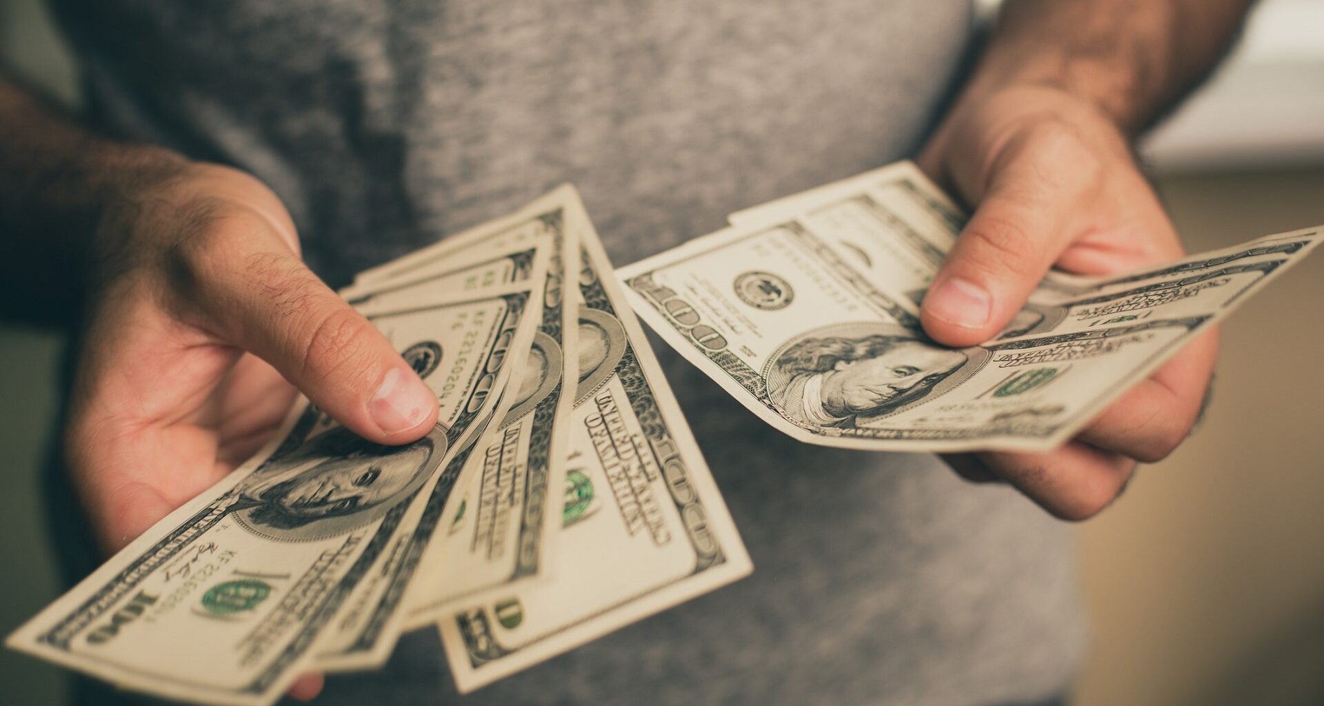A man holds dollars in his hands stock photo