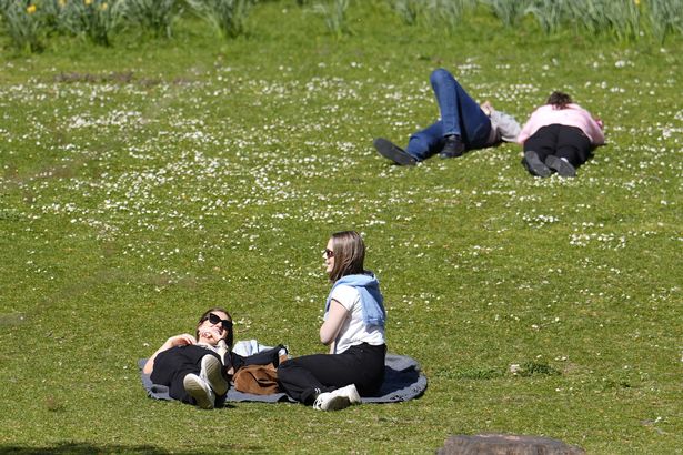 People enjoying the sunny weather in St James's Park in London