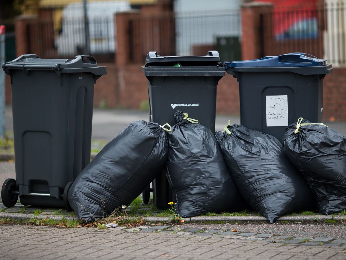 Rubbish bags piled up in front of bins in Moseley Road, Birmingham