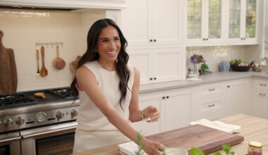 Meghan Markle, Duchess of Sussex, smiles while hosting in a kitchen during an episode of her Netflix series With Love, Meghan, part of her lifestyle brand launch.