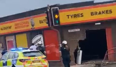 Residents hear 'loud bang' as car ploughs into side of National Tyres garage