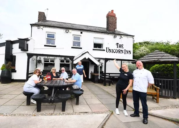 Charley Curzon, manager, and Sean Wilde, head chef, far right, with regulars at the Unicorn Inn, Cronton