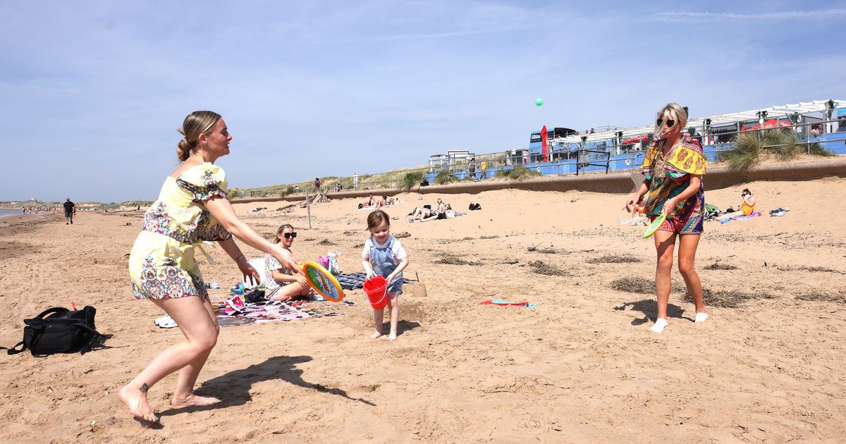 Crosby beach full of people enjoying mini-heatwave