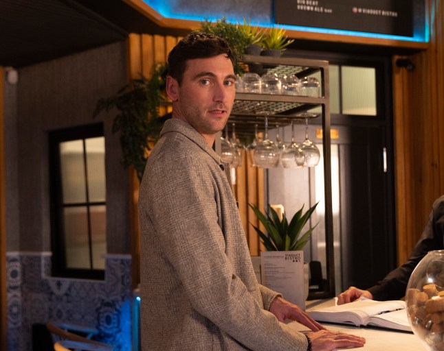 Kit stands in the Bistro looking curious in Corrie