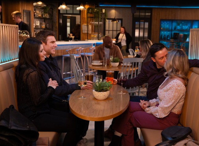 Theo and his partner Danielle sit in a booth as Todd kisses Sarah in Corrie