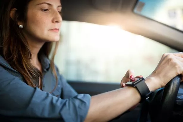 According to GOV.UK, even holding a device that can send or receive data while driving is against the law