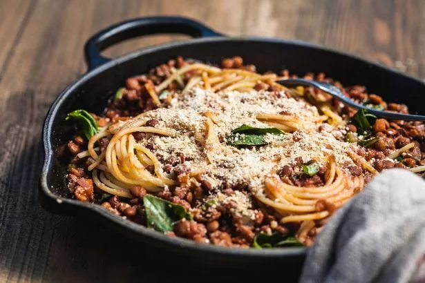 Quinoa and corn spagetti noodles twisted through a rich tomato based sauce of lentils, basil and red wine, served right from the skillet.