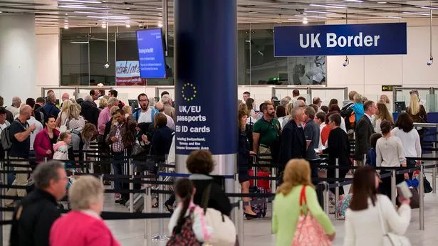 Image of line of passengers waiting to pass through Border Force at the airport