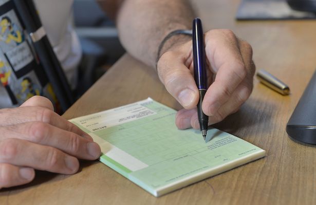 a GP writing a prescription