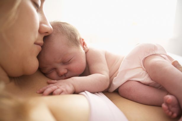 Mother cradling newborn infant