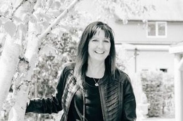 A woman with dark hair smiling 