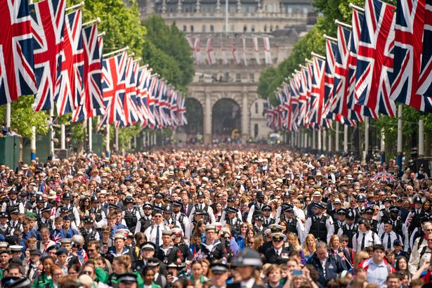 Crowds on The Mall watch, as Queen Elizabeth II makes an appearance on the balcony of Buckingham Palace