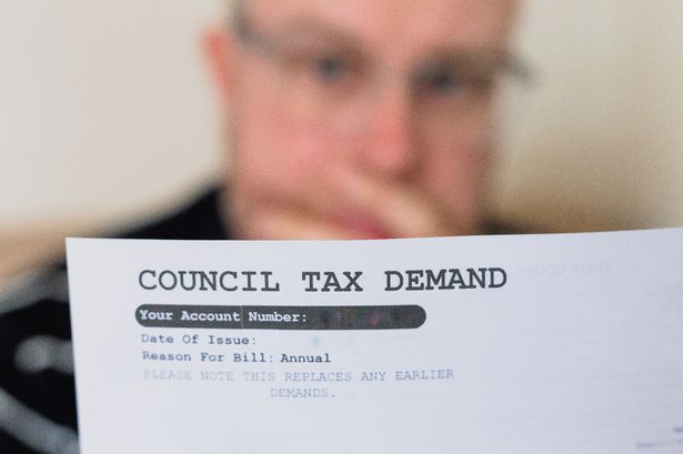 Man paying council tax bill