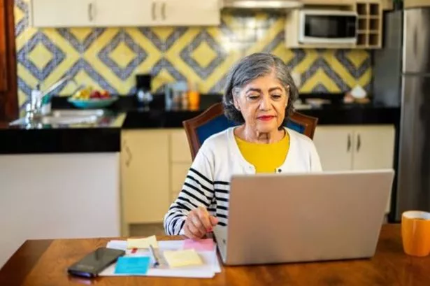 Older person checking state pension payment on computer