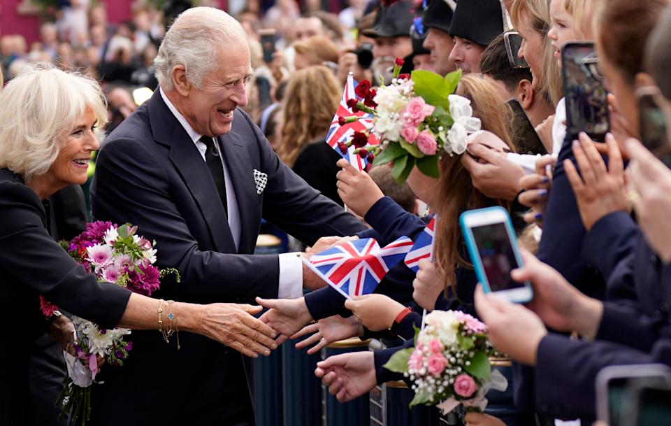 King Charles and Queen Camilla shaking hands with fans in September 2022