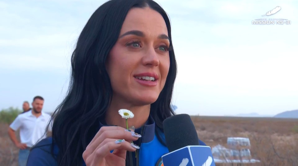 Katy Perry holding a daisy at a Blue Origin launch.