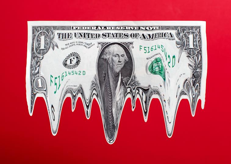 U.S. dollar bill melting against a red background, symbolizing financial instability or currency devaluation