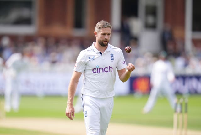 England's Chris Woakes tosses a ball as he walks back to his mark.